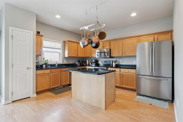 263 SE Booth Ave, Waukee, IA 50266 - kitchen featuring stainless steel appliances, light wood-type flooring, dark countertops, a kitchen island, and recessed lighting
