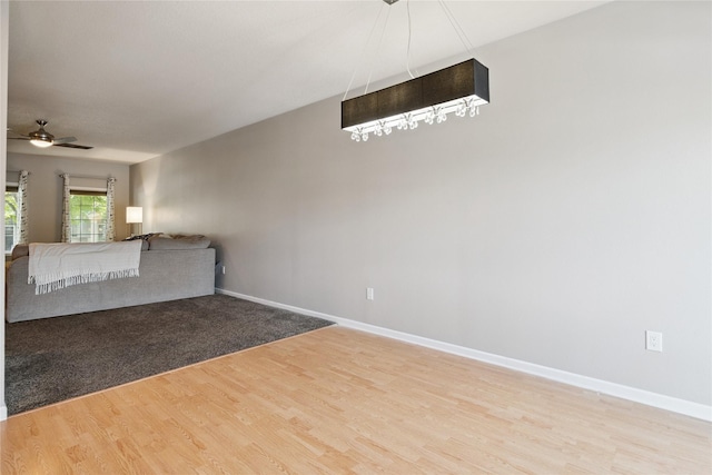 263 SE Booth Ave, Waukee, IA 50266 - unfurnished living room featuring light wood-style floors and ceiling fan