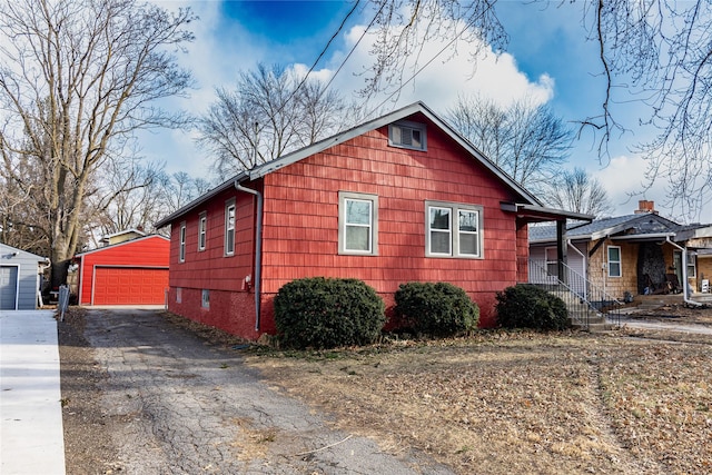 3021 49th St, Des Moines, IA 50310 - view of home's exterior featuring a detached garage and an outbuilding