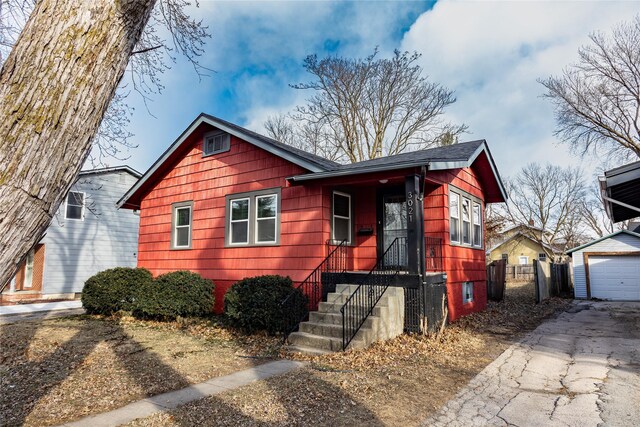 3021 49th St, Des Moines, IA 50310 - bungalow-style house featuring driveway and an outbuilding