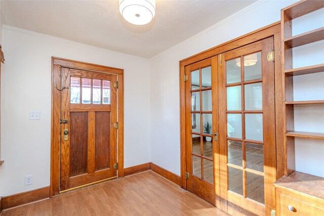 3021 49th St, Des Moines, IA 50310 - foyer entrance featuring light wood-style floors, crown molding, and french doors