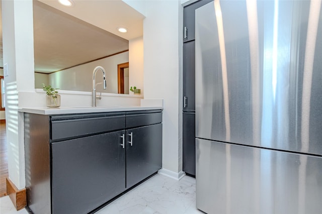 3021 49th St, Des Moines, IA 50310 - kitchen featuring freestanding refrigerator, light marble finish floors, light countertops, and recessed lighting