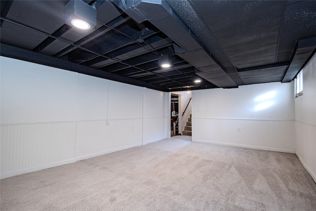 3021 49th St, Des Moines, IA 50310 - below grade area featuring carpet floors, stairs, and a wainscoted wall