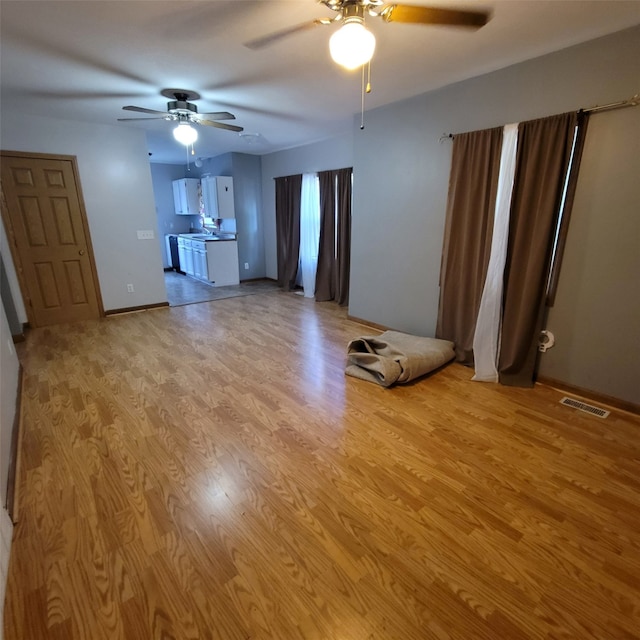 3901 3rd St, Des Moines, IA 50313 - unfurnished living room with a ceiling fan and light wood-style flooring