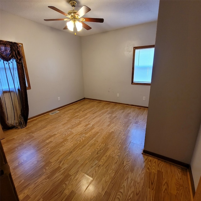 3901 3rd St, Des Moines, IA 50313 - spare room with light wood-type flooring and ceiling fan