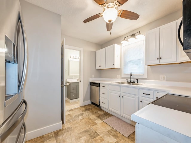 715 N Fremont St, Stuart, IA 50250 - kitchen featuring stainless steel appliances, white cabinetry, light stone finish flooring, and a ceiling fan