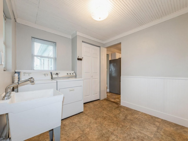 715 N Fremont St, Stuart, IA 50250 - laundry area featuring separate washer and dryer, ornamental molding, and a wainscoted wall