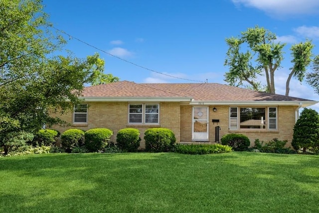 7210 Beechwood Dr, Urbandale, IA 50322 - ranch-style home with a front lawn, brick siding, and a shingled roof