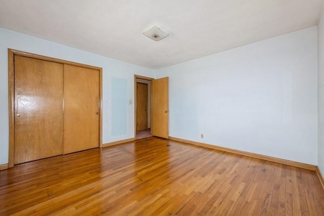 7210 Beechwood Dr, Urbandale, IA 50322 - unfurnished bedroom with light wood-style flooring and a closet