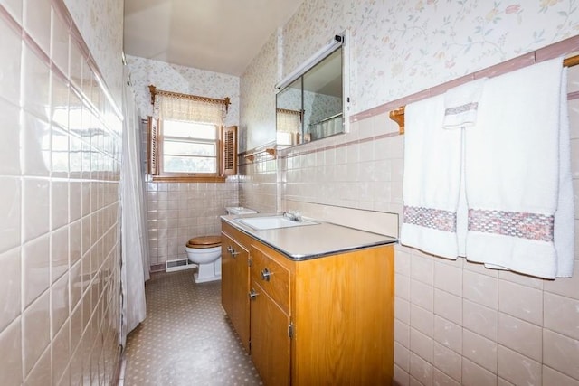 7210 Beechwood Dr, Urbandale, IA 50322 - bathroom featuring tile walls, wallpapered walls, vanity, wainscoting, and a shower with curtain