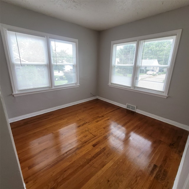 3224 SW 13th Pl, Des Moines, IA 50315 - empty room featuring wood finished floors and baseboards
