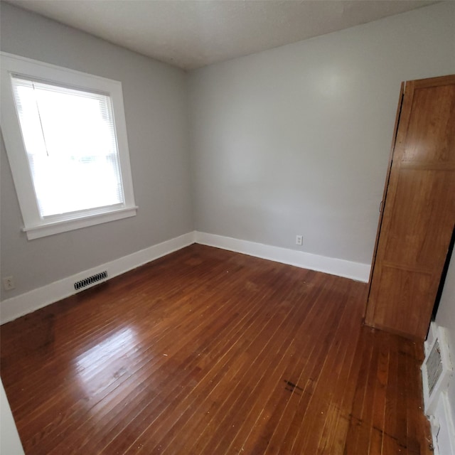 3224 SW 13th Pl, Des Moines, IA 50315 - spare room with dark wood-type flooring and baseboards