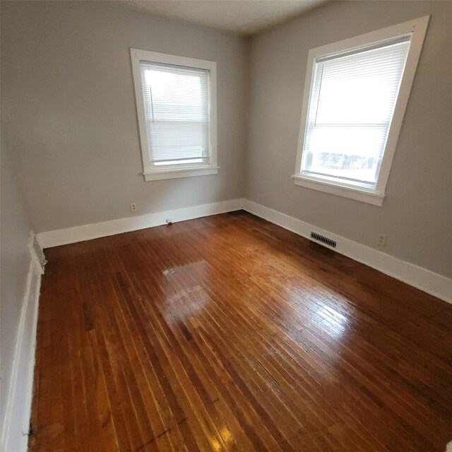 3224 SW 13th Pl, Des Moines, IA 50315 - spare room with healthy amount of natural light and hardwood / wood-style floors