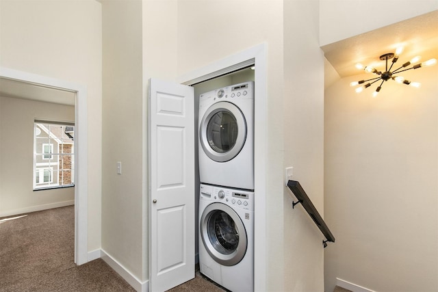 8302 Westown Pkwy Unit 1102, West Des Moines, IA 50266 - laundry area with estacked washer and dryer, dark colored carpet, and a chandelier