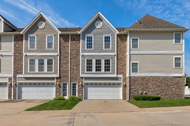 8302 Westown Pkwy Unit 1102, West Des Moines, IA 50266 - townhome / multi-family property featuring stone siding, a garage, and concrete driveway