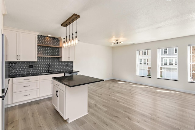 8302 Westown Pkwy Unit 1102, West Des Moines, IA 50266 - kitchen featuring dark countertops, backsplash, a kitchen island, open shelves, and light wood-type flooring