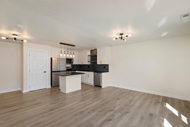 8302 Westown Pkwy Unit 1102, West Des Moines, IA 50266 - kitchen with appliances with stainless steel finishes, tasteful backsplash, open floor plan, and white cabinetry
