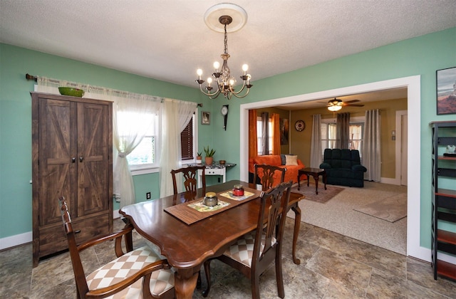 5910 Tonka Ave, Des Moines, IA 50312 - dining area featuring a chandelier and a textured ceiling
