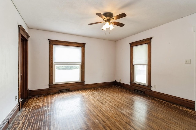 1805 S D Ave, Lovilia, IA 50150 - unfurnished room with dark wood-style floors and a ceiling fan