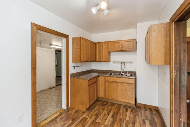 1805 S D Ave, Lovilia, IA 50150 - kitchen featuring brown cabinetry, dark wood-style floors, and dark countertops
