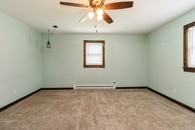 1805 S D Ave, Lovilia, IA 50150 - empty room featuring baseboard heating, carpet flooring, and a ceiling fan