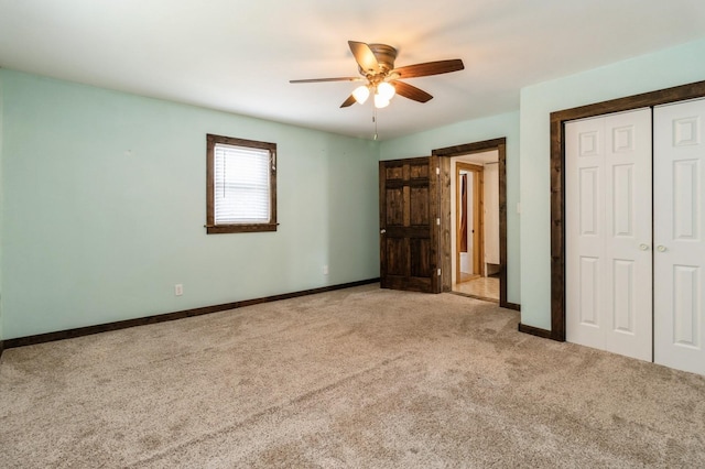 1805 S D Ave, Lovilia, IA 50150 - unfurnished bedroom with light carpet, a closet, and ceiling fan
