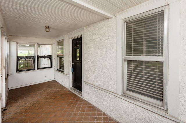 802 Fulton Dr, Des Moines, IA 50315 - unfurnished sunroom with tile patterned flooring and a textured wall