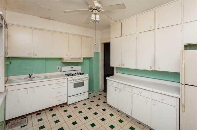 802 Fulton Dr, Des Moines, IA 50315 - kitchen featuring white appliances, light countertops, backsplash, and under cabinet range hood