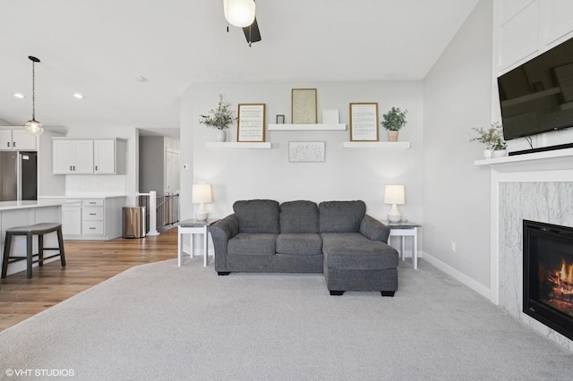 2670 Long Ave, Van Meter, IA 50261 - living room featuring light carpet, a premium fireplace, recessed lighting, ceiling fan, and light wood-style floors