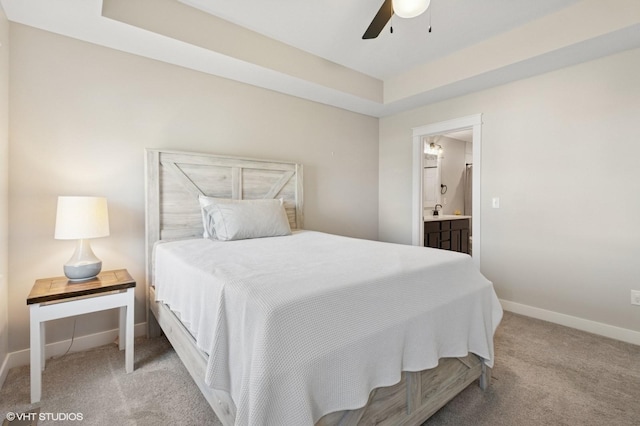 2670 Long Ave, Van Meter, IA 50261 - bedroom with light carpet, ensuite bath, a ceiling fan, and a raised ceiling