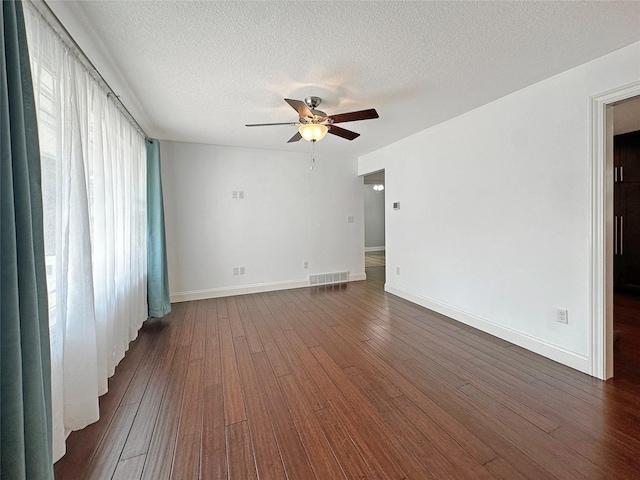 2814 Chicago Ave, Des Moines, IA 50317 - unfurnished room featuring ceiling fan, dark wood-style floors, and a textured ceiling