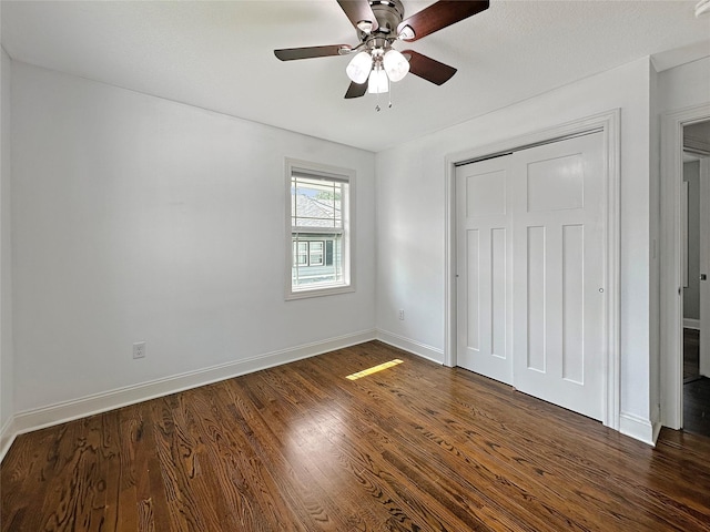 2814 Chicago Ave, Des Moines, IA 50317 - unfurnished bedroom featuring dark wood-style flooring, a closet, and ceiling fan