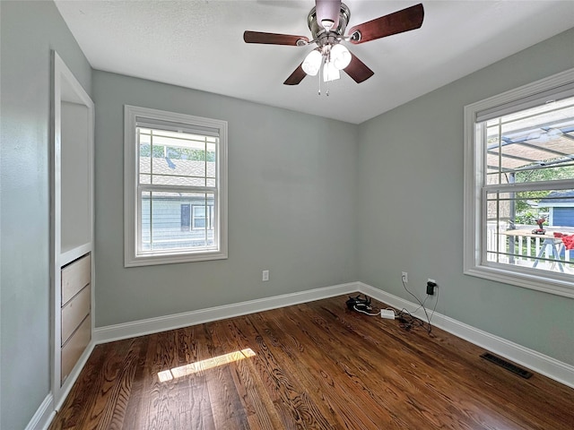 2814 Chicago Ave, Des Moines, IA 50317 - empty room with dark wood-style floors and a ceiling fan