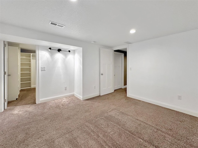 2814 Chicago Ave, Des Moines, IA 50317 - unfurnished bedroom featuring carpet, a spacious closet, and recessed lighting