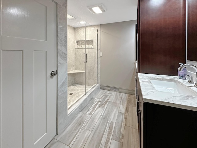 2814 Chicago Ave, Des Moines, IA 50317 - full bath with a stall shower, vanity, and wood finish floors
