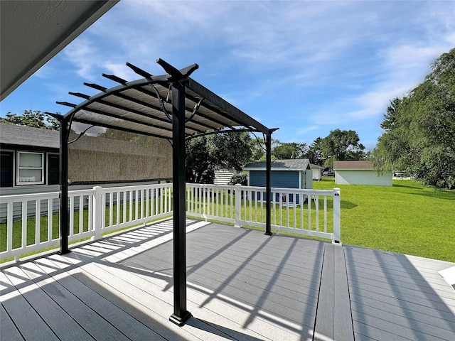 2814 Chicago Ave, Des Moines, IA 50317 - wooden terrace with a pergola, a lawn, and an outbuilding