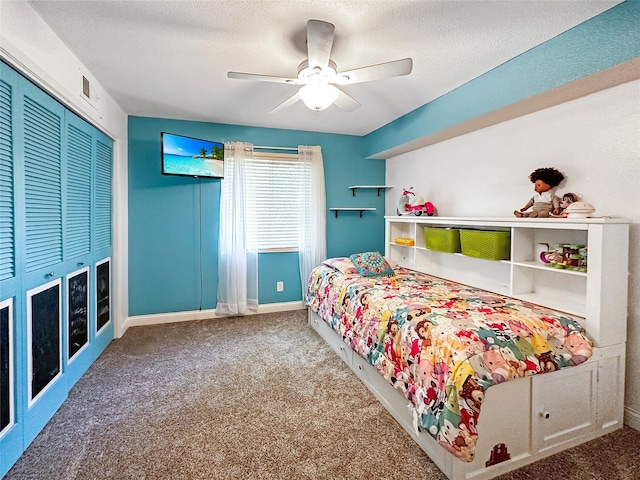 9513 University Ave Unit 12, Clive, IA 50325 - carpeted bedroom with a closet, ceiling fan, and a textured ceiling