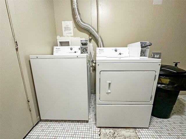 9513 University Ave Unit 12, Clive, IA 50325 - laundry room featuring washing machine and dryer and light tile patterned floors
