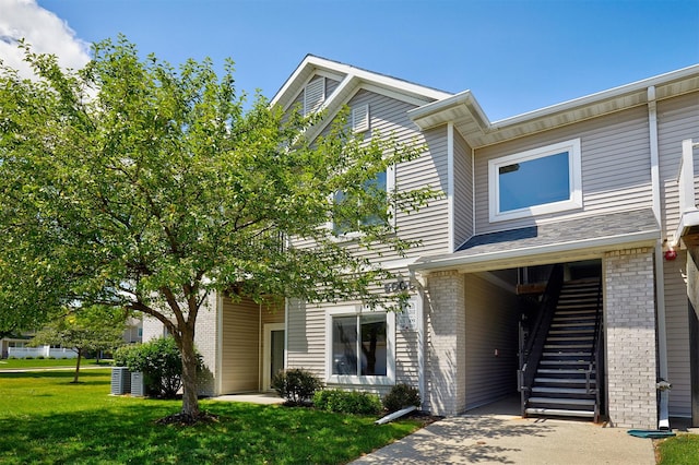 8601 Westown Pkwy Unit 5114, West Des Moines, IA 50266 - view of front facade with brick siding, stairway, and a front lawn