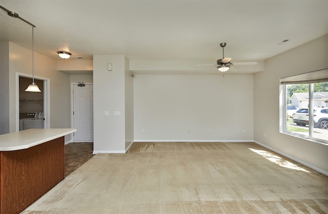 8601 Westown Pkwy Unit 5114, West Des Moines, IA 50266 - unfurnished living room featuring a ceiling fan, washer and dryer, and carpet