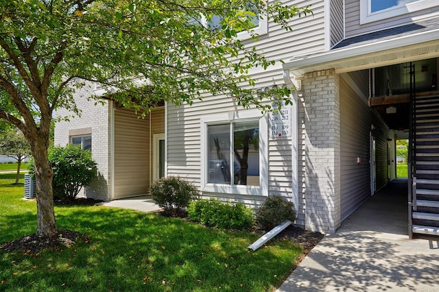 8601 Westown Pkwy Unit 5114, West Des Moines, IA 50266 - doorway to property featuring brick siding and a lawn