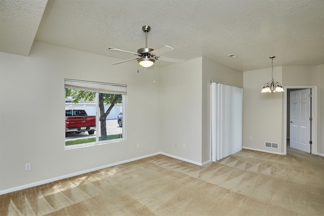 8601 Westown Pkwy Unit 5114, West Des Moines, IA 50266 - empty room featuring a textured ceiling, carpet floors, a chandelier, and ceiling fan