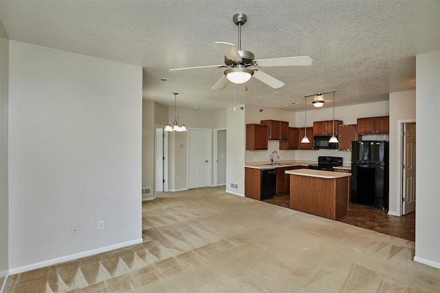 8601 Westown Pkwy Unit 5114, West Des Moines, IA 50266 - kitchen with black appliances, light colored carpet, light countertops, a kitchen island, and ceiling fan