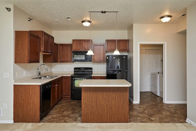 8601 Westown Pkwy Unit 5114, West Des Moines, IA 50266 - kitchen with black appliances, washer and clothes dryer, a kitchen island, light countertops, and a textured ceiling