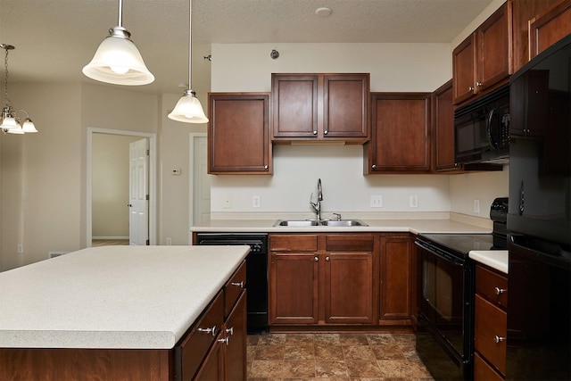 8601 Westown Pkwy Unit 5114, West Des Moines, IA 50266 - kitchen featuring black appliances, light countertops, hanging light fixtures, a kitchen island, and stone finish flooring