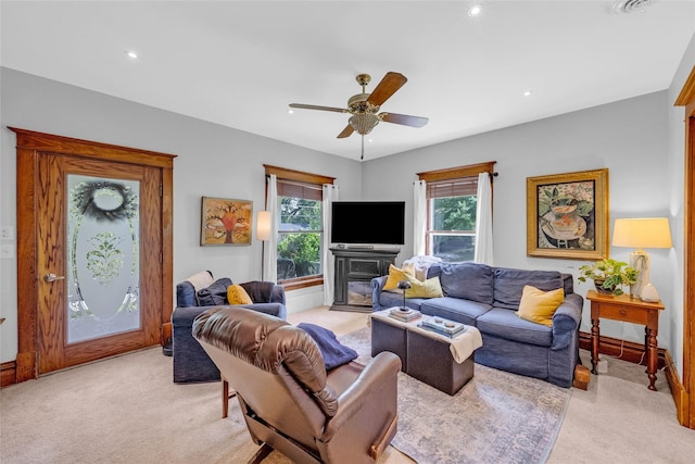 3602 64th St, Urbandale, IA 50322 - living room featuring light carpet, a glass covered fireplace, a ceiling fan, and recessed lighting