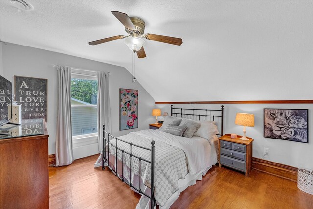 3602 64th St, Urbandale, IA 50322 - bedroom featuring lofted ceiling, wood finished floors, a ceiling fan, and a textured ceiling