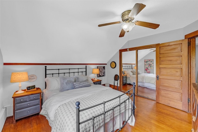 3602 64th St, Urbandale, IA 50322 - bedroom with light wood-style flooring, vaulted ceiling, a closet, and a ceiling fan