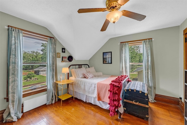 3602 64th St, Urbandale, IA 50322 - bedroom featuring wood finished floors, vaulted ceiling, and ceiling fan