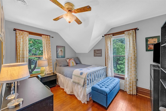 3602 64th St, Urbandale, IA 50322 - bedroom featuring multiple windows, wood finished floors, lofted ceiling, and a ceiling fan